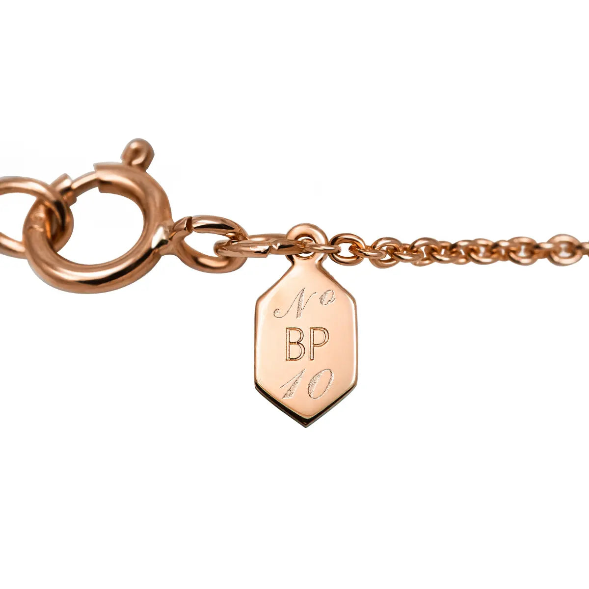 Rose-gold necklace clasp with engraved shield charm marked BP 10