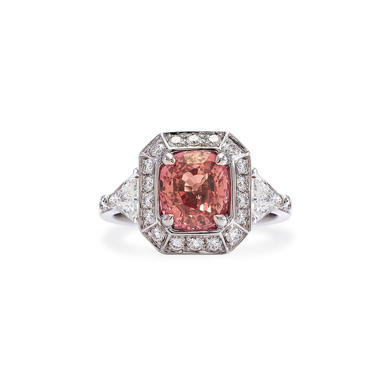 The Monument Trilogy Sapphire Ring features a rare Padparadscha, a sunset-hued variety of corundum (the mineral family of Sapphires and Rubies) — a queen of sorts in the gemstone world, and incredibly sought after by collectors and jewellery connoisseurs.   This ring is a part of our Sapphire Signatures, a collection of 18K solid gold rings that feature incredibly rare, untreated Natural Sapphires handpicked by B.P. de Silva Gem Specialists.