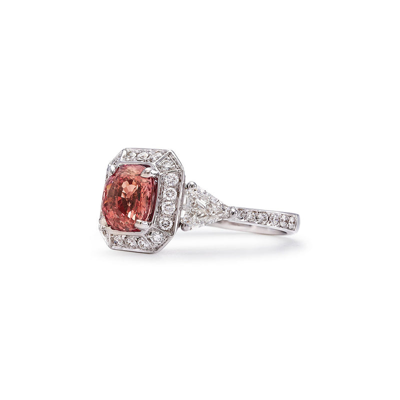 The Monument Trilogy Sapphire Ring features a rare Padparadscha, a sunset-hued variety of corundum (the mineral family of Sapphires and Rubies) — a queen of sorts in the gemstone world, and incredibly sought after by collectors and jewellery connoisseurs. This ring is a part of our Sapphire Signatures, a collection of 18K solid gold rings that feature incredibly rare, untreated Natural Sapphires handpicked by B.P. de Silva Gem Specialists.